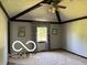 Cozy bedroom with a patterned ceiling and window with natural light at 8835 Winding Ridge Rd, Indianapolis, IN 46217