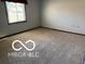 Bright bedroom with a large window offering natural light and neutral carpet, ready for personalization at 8835 Winding Ridge Rd, Indianapolis, IN 46217