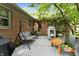 Covered back patio with swing, playset, and patterned outdoor rug at 8909 Ellington Dr, Indianapolis, IN 46234
