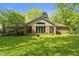 Spacious backyard showing sunroom windows, deck, and landscaped lawn at 8909 Ellington Dr, Indianapolis, IN 46234