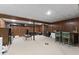 Finished basement with wood paneled walls, carpet flooring, and a mini bar at 8909 Ellington Dr, Indianapolis, IN 46234
