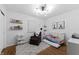 Charming Bedroom with a cozy chair, white crib, and stylish decor, perfect for a sanctuary at 8909 Ellington Dr, Indianapolis, IN 46234