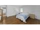 Cozy bedroom features hardwood floors, a comfortable bed, and ample storage with closet and drawers at 8909 Ellington Dr, Indianapolis, IN 46234