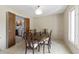 Traditional dining room featuring carpet, a wooden table with chairs, and view into kitchen at 8909 Ellington Dr, Indianapolis, IN 46234
