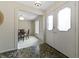 Foyer with tile flooring, decorative double doors, and archway leading into dining room with carpet at 8909 Ellington Dr, Indianapolis, IN 46234