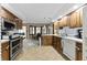 Well-lit kitchen features light countertops, wood cabinets, and modern appliances for culinary enthusiasts at 8909 Ellington Dr, Indianapolis, IN 46234