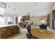 Open concept kitchen and living area features wood cabinets, brick accents and natural light at 8909 Ellington Dr, Indianapolis, IN 46234