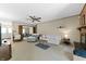 Cozy living room features comfortable seating, a fireplace, and natural light, with carpeted floors at 8909 Ellington Dr, Indianapolis, IN 46234