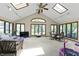 Sunroom boasts vaulted ceilings, skylights, large windows, and comfortable seating areas at 8909 Ellington Dr, Indianapolis, IN 46234