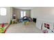 Spacious carpeted playroom with ample natural light and a variety of toys, creating a fun environment at 8909 Ellington Dr, Indianapolis, IN 46234