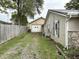 Exterior view of the backyard featuring a detached garage and partial fencing at 909 Sullivan St, Alexandria, IN 46001