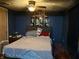 Cozy bedroom with a plush bed, a ceiling fan, and dim lighting at 909 Sullivan St, Alexandria, IN 46001