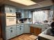 Functional kitchen with blue cabinetry, a built-in oven, and ample counter space at 909 Sullivan St, Alexandria, IN 46001