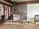 Cozy living room featuring a wood-burning stove with a stone base, surrounded by eclectic decor and artistic touches at 909 Sullivan St, Alexandria, IN 46001