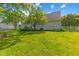 Lush green backyard provides a serene outdoor space, enhanced by mature trees, a fence, and a well-manicured lawn at 10172 Watkins Ct, Indianapolis, IN 46234