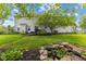 Expansive backyard featuring lush greenery, a serene pond, mature trees and ample space for outdoor activities at 10172 Watkins Ct, Indianapolis, IN 46234