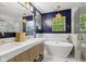 Stylish bathroom with modern fixtures, a soaking tub, and beautiful tile work at 10172 Watkins Ct, Indianapolis, IN 46234