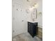 Stylish bathroom featuring a vanity with marble countertop and brass accents, complemented by decorative lighting and modern fixtures at 10172 Watkins Ct, Indianapolis, IN 46234