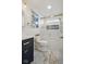 Elegant bathroom featuring modern fixtures, a framed print of Menorca, and unique tiling at 10172 Watkins Ct, Indianapolis, IN 46234