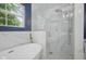 This bathroom features a modern tub and shower, with sleek marble and unique geometric tiling for a spa-like aesthetic at 10172 Watkins Ct, Indianapolis, IN 46234