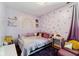 Charming bedroom with purple heart decals, plush furnishings, and decorative rainbow wall art at 10172 Watkins Ct, Indianapolis, IN 46234