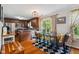 Inviting dining area with hardwood floors, modern table, and a view to the kitchen at 10172 Watkins Ct, Indianapolis, IN 46234