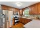 Well-equipped kitchen featuring stainless steel appliances, wood cabinets, and mosaic tile backsplash at 10172 Watkins Ct, Indianapolis, IN 46234