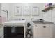 Modern laundry room with front load Maytag washer and dryer units and playful wall art at 10172 Watkins Ct, Indianapolis, IN 46234