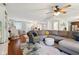 Spacious living area with hardwood floors, a large gray sectional sofa, and ample natural light at 10172 Watkins Ct, Indianapolis, IN 46234