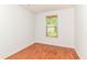 An empty bedroom featuring wood-look floors and a bright window at 1030 Longwell Pl, Indianapolis, IN 46240