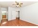 This empty bedroom offers wood-look floors, and access to the bathroom at 1030 Longwell Pl, Indianapolis, IN 46240
