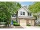 Attractive two-story home featuring a two-car garage, brick accents, and mature trees at 1030 Longwell Pl, Indianapolis, IN 46240