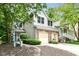 Charming two-story home featuring brick accents, a two-car garage, and landscaped front yard at 1030 Longwell Pl, Indianapolis, IN 46240