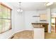 Kitchen area featuring tan countertops, tile floors and a light fixture at 1030 Longwell Pl, Indianapolis, IN 46240