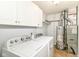 Bright laundry room with washer, dryer, and upper cabinets for storage at 1030 Longwell Pl, Indianapolis, IN 46240
