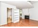 Spacious living room featuring a fireplace, built-in shelves, and hardwood floors at 1030 Longwell Pl, Indianapolis, IN 46240