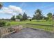 Large backyard with wood deck, mature trees, and storage shed at 105 Meadowview Ln, Greenwood, IN 46142