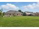 Spacious backyard with lush lawn and brick home exterior at 105 Meadowview Ln, Greenwood, IN 46142