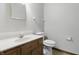 Neutral bathroom featuring a wood vanity, sink, toilet, and a large mirror at 105 Meadowview Ln, Greenwood, IN 46142