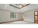 Spacious bedroom featuring tray ceilings and a glimpse into the bathroom at 105 Meadowview Ln, Greenwood, IN 46142
