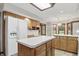 Bright kitchen featuring a large island, wood cabinets, and ample natural light from a skylight and windows at 105 Meadowview Ln, Greenwood, IN 46142