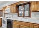 Traditional kitchen with wooden cabinets, white countertops, and appliances, plus a window above the sink at 105 Meadowview Ln, Greenwood, IN 46142