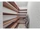 Walk-in pantry with wooden shelving and patterned wallpaper at 105 Meadowview Ln, Greenwood, IN 46142