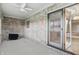Sunroom with exposed brick, ceiling fan and access to the backyard at 105 Meadowview Ln, Greenwood, IN 46142