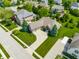 Aerial view showcasing a home with manicured lawns, mature landscaping, and a spacious driveway at 10784 Giselle Way, Fishers, IN 46040