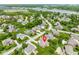 Expansive aerial view of a home in a lush, green neighborhood with mature trees and a nearby lake at 10784 Giselle Way, Fishers, IN 46040
