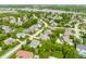 Aerial view of neighborhood featuring homes, mature trees, and winding roads with a lake in the distance at 10784 Giselle Way, Fishers, IN 46040