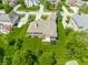 Aerial view of a home with a manicured lawn, lush greenery, and a backyard deck at 10784 Giselle Way, Fishers, IN 46040