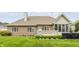 Well-manicured backyard featuring a hot tub, deck, and lush green lawn at 10784 Giselle Way, Fishers, IN 46040