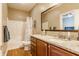 Well-lit bathroom featuring a granite countertop, modern fixtures, and a shower-tub combination at 10784 Giselle Way, Fishers, IN 46040